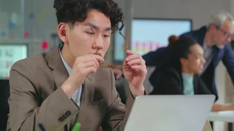 Young concentrated asian programmer in glasses Stock Footage 99252389