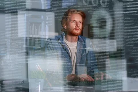 Young concentrated computer developer writing new code 스톡 사진