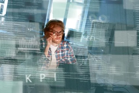 Young concentrated computer developer writing new code in glasses 스톡 사진