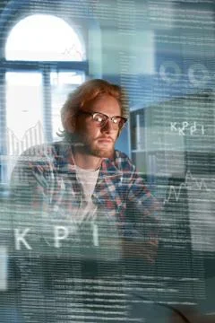 Young concentrated computer developer writing new code 스톡 사진