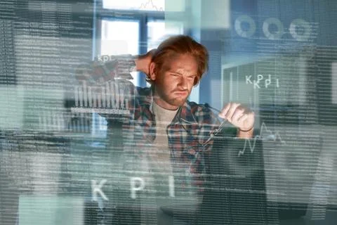 Young concentrated computer developer writing new code Stock Photos