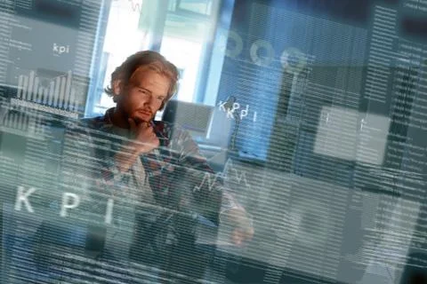 Young concentrated computer developer writing new code Stockfoto's