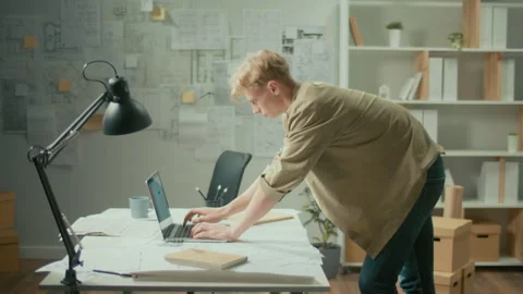 Young Concentrated Engineer Working on the Laptop in Modern Minimalistic Office Stock Footage 239110192