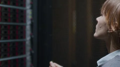 Young Concentrated Female IT Technician Checking Mainframe in Data Center Stock Footage 303554001