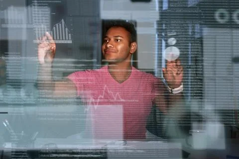 Young concentrated indian data analyst using big data to make solutions Stock Photos