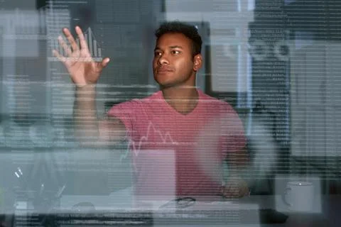 Young concentrated indian data analyst looking over the data Stock Photos