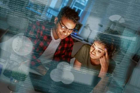 Young concentrated indian data analysts looking over the data Stock Photos