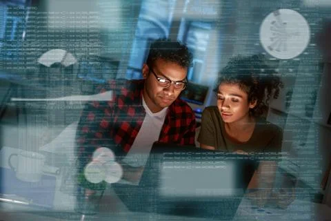 Young concentrated indian data analysts looking over the data Stock Photos