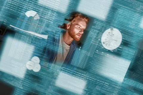 Young concentrated red haired data analyst looking over the data 스톡 사진