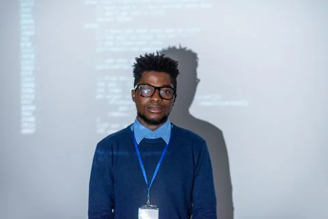 Young confident it-manager or software developer standing by interactive screen Stock Photos