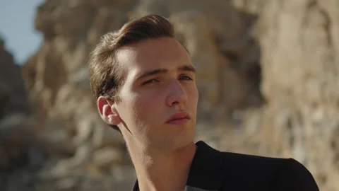 A young, confident man casts a cursory glance to the camera. Stock Footage 305588946