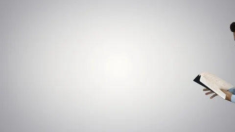 Young confused man trying to read smart book misunderstanding content while Stock Footage 108067047