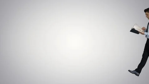Young confused man trying to read smart book misunderstanding content while Stock Footage 117218262