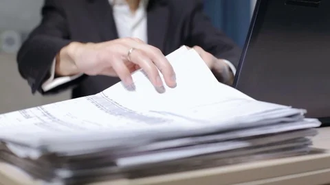 A young construction engineer inspects blueprints in the office Stock Footage 83084827