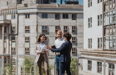 Young construction engineers discussing project while standing on a construction Stock Photos