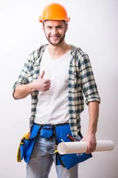 Young construction man with a project on building. Stock Photos