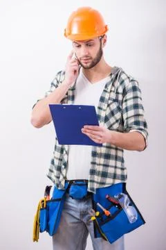 Young construction man with a project on building. Stock Photos