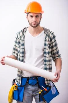 Young construction man with a project on building. Stock Photos