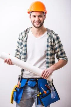 Young construction man with a project on building. Stock Photos
