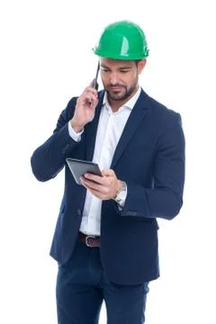 Young construction manager calling and using tablet isolated Stock Photos