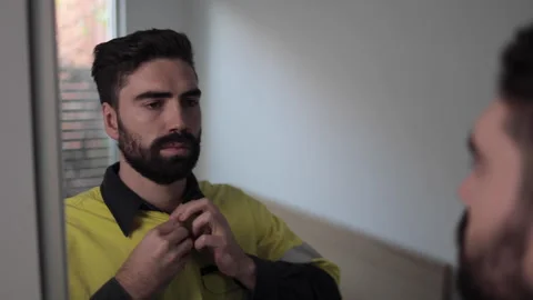 Young construction worker getting dressed in morning before work Stock Footage 240395681