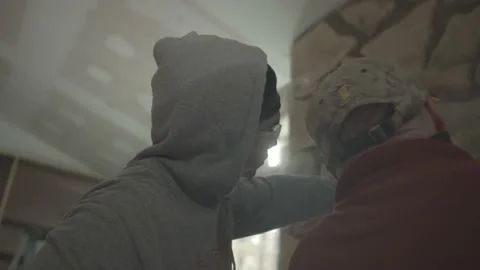 Young construction worker is pointing at the fireplace Stock-Footage 146197729