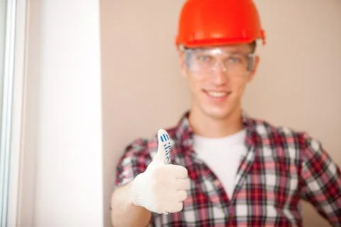Young construction worker with thumbs up Foto stock