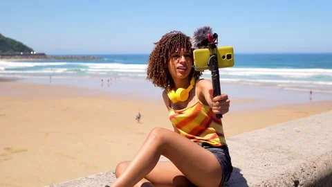 Young content creator broadcasting live from the beach Stock Footage 310777267