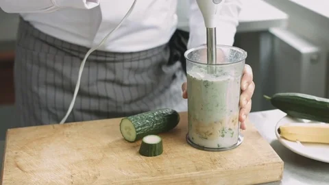 Young cook in uniform preparing green smoothie Stock Footage 74507344
