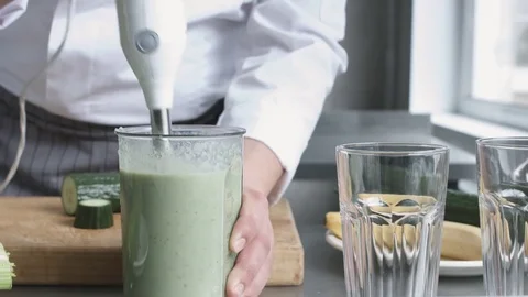 Young cook in uniform preparing vegetable smoothie Stock Footage 74507628