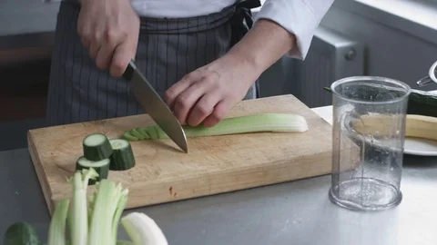 Young cook in uniform preparing vegetable smoothie Stock-Footage 74508288