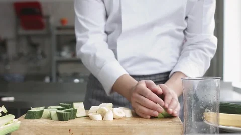Young cook in uniform preparing vegetable smoothie Stock Footage 74508787