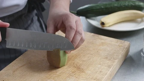 Young cook in uniform preparing vegetable smoothie Video stock 74509021