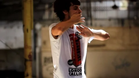 Young cool man Hip hop acrobatic and break dancing in club with lights, smoke Stock Footage 159610381