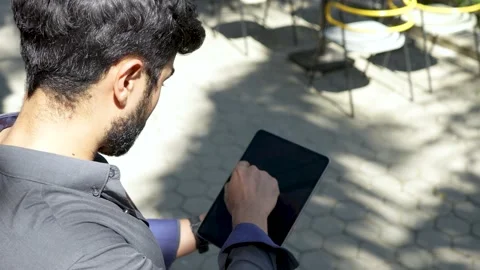 A young cool man keep touching his blank screen tablet Stock Footage 204867502