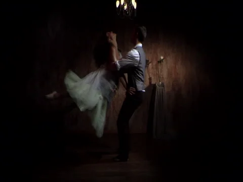 Young couple 20's performing choreographed dance together with romantic lighting Stock Footage 45273067