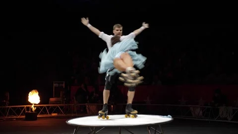 A young couple of acrobats on roller skates perform in a circus. Stock Footage 311151913
