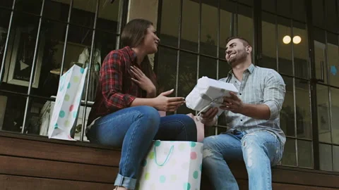 Young couple admiring and comparing shopping gifts from the days shopping. Vídeo Stock 199632123