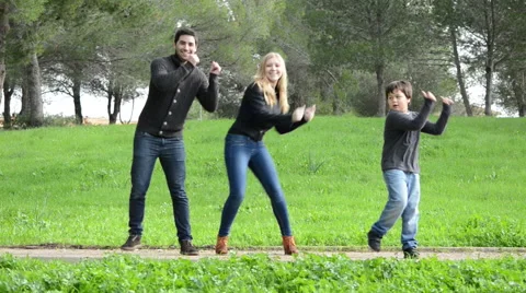 Young couple and child dancing in a park Stock Footage 45123787