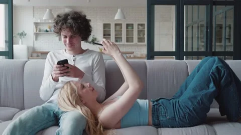Young couple and ignoring each other looking at smartphones. Man sitting in Stock Footage 161152449