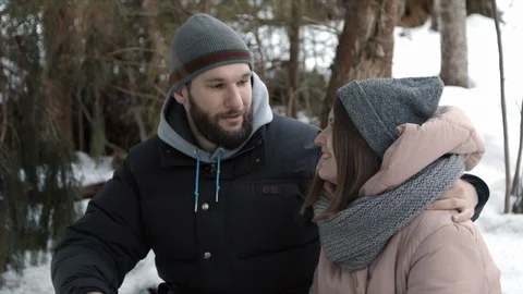 Young couple are sitting in the forest and talking Stock Footage 123523818