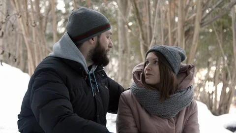 Young couple are sitting in the forest and talking Stock Footage 123526414