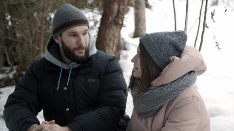 Young couple are sitting in the forest and talking Stock Footage 123532067