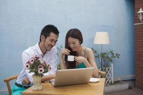 A young couple are using a computer Stock Photos