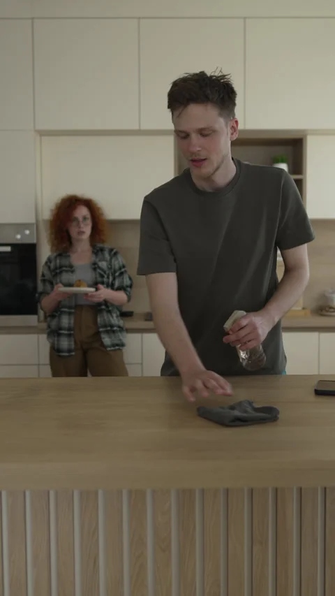 Young couple arguing while cleaning the kitchen table Stock Footage 333261349