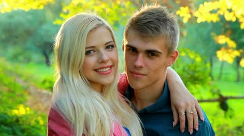 Young couple on background of autumn trees. Stock Footage 12326436
