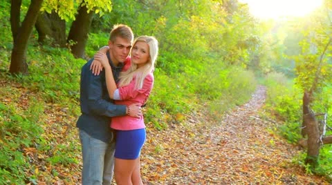 Young couple on background of autumn trees. Stock Footage 12381259