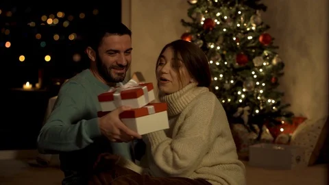 Young couple on the background of the Christmas tree Stock Footage 120636434
