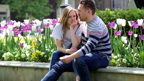 Young couple on a background of tulips Video stock 75525678