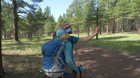 A young couple backpacking and taking a selfie in the forest Stock Footage 94663005